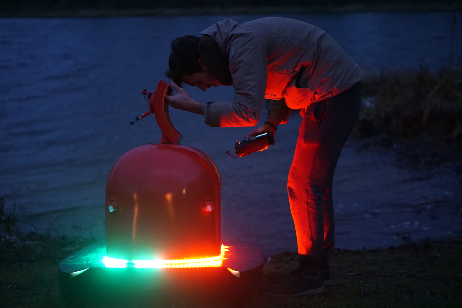 An LED-lit autonomous buoy on the lake at dusk